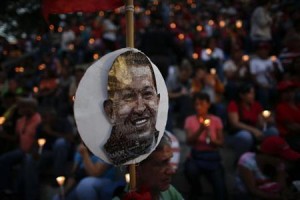 People hold lit candles during a praying ceremony for the health of Venezuelan President Chavez in Caracas